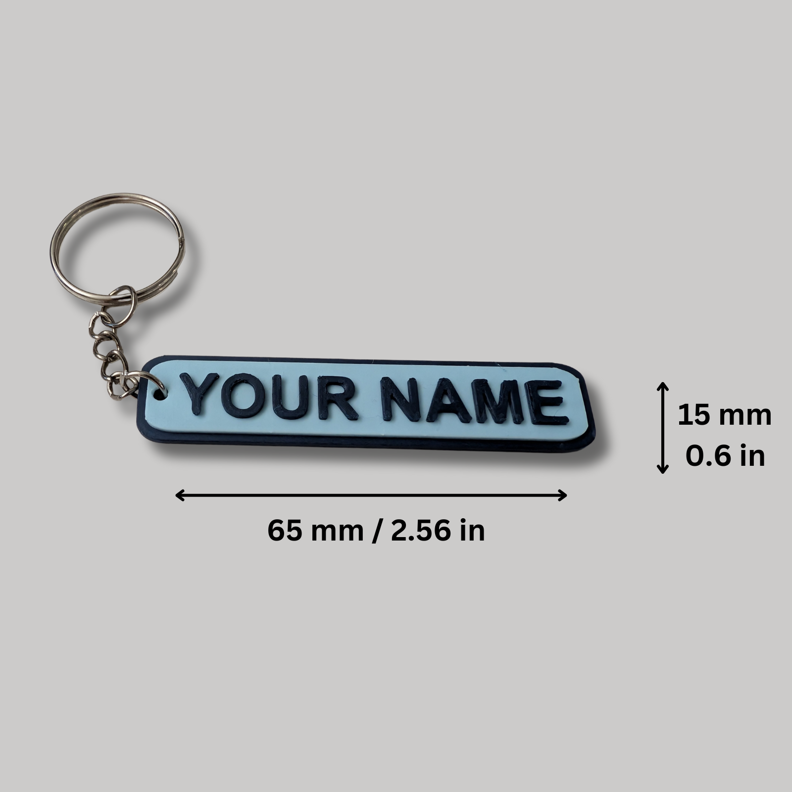 Keychain with 'YOUR NAME' text and dimensions on a gray background