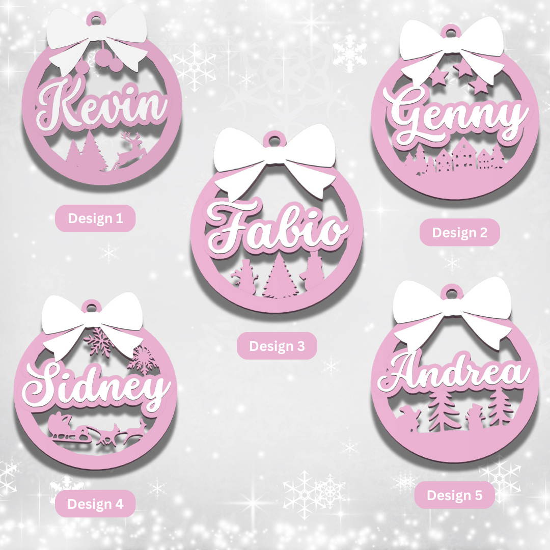 Five pink personalized ornaments with names and designs on a snowy background
