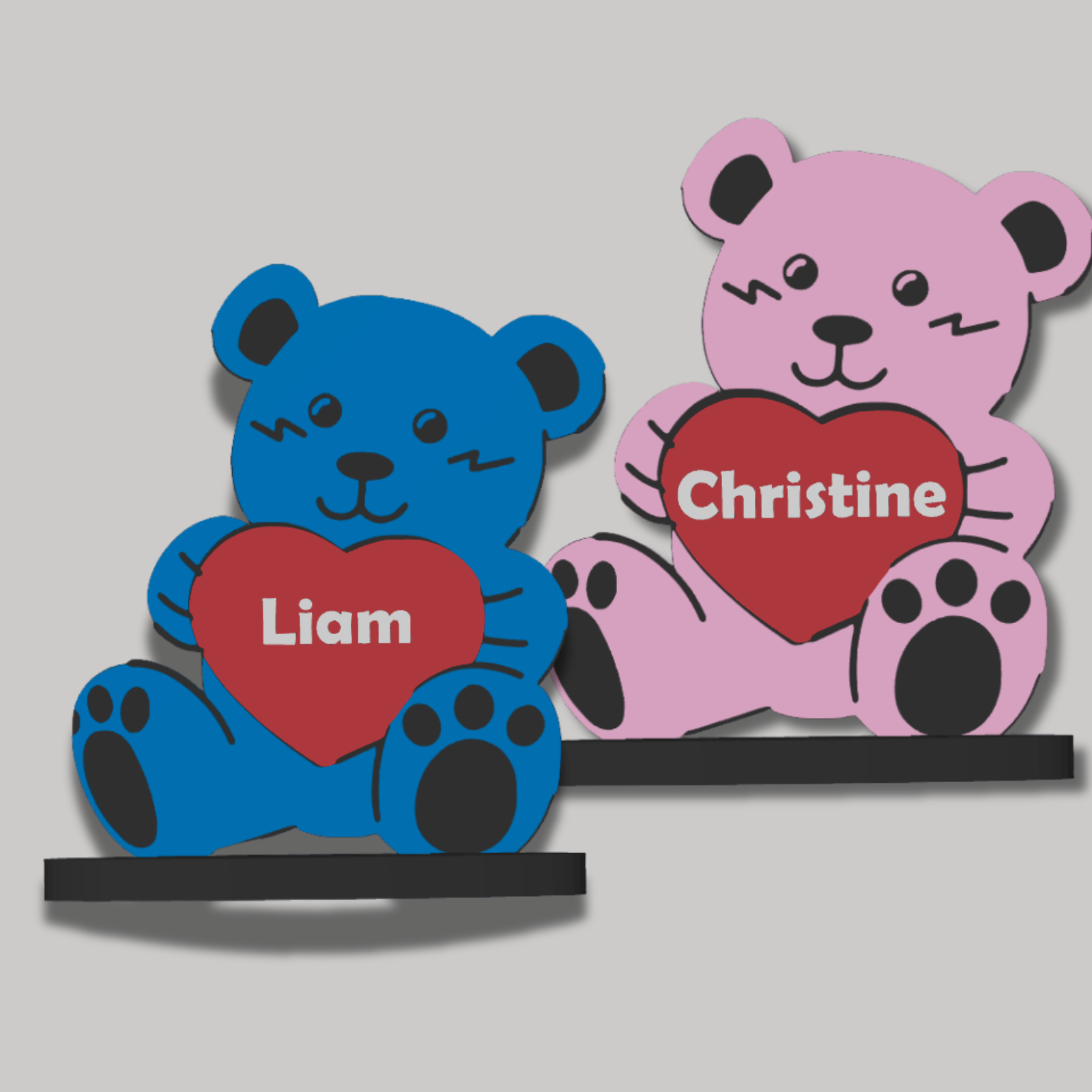 Two teddy bears with hearts, one blue and one pink, on a gray background.