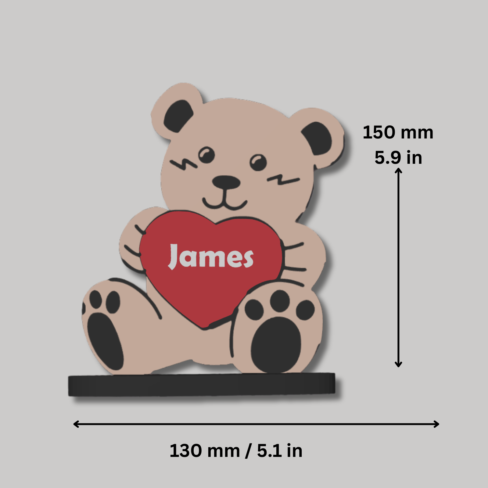 Bear-shaped decorative item with a heart and 'James' text, shown with measurements on a gray background.
