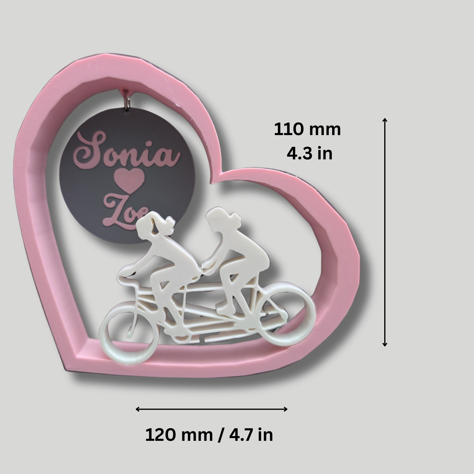 Heart-shaped pink frame with a tandem bicycle cut-out and dimensions.