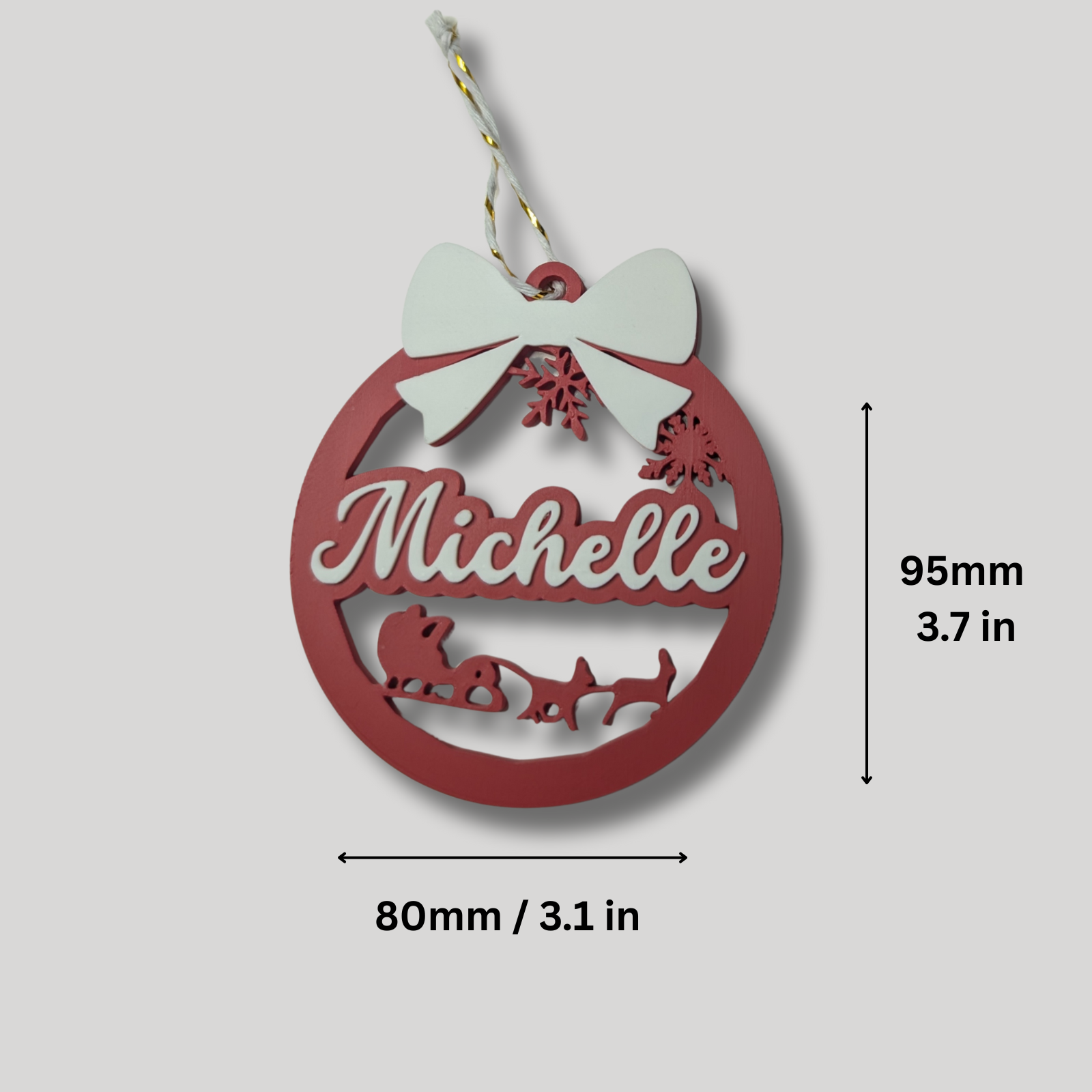 Red Christmas ornament with 'Michelle' and Santa Claus silhouette, featuring a white bow and snowflakes, with measurements on a light gray background.