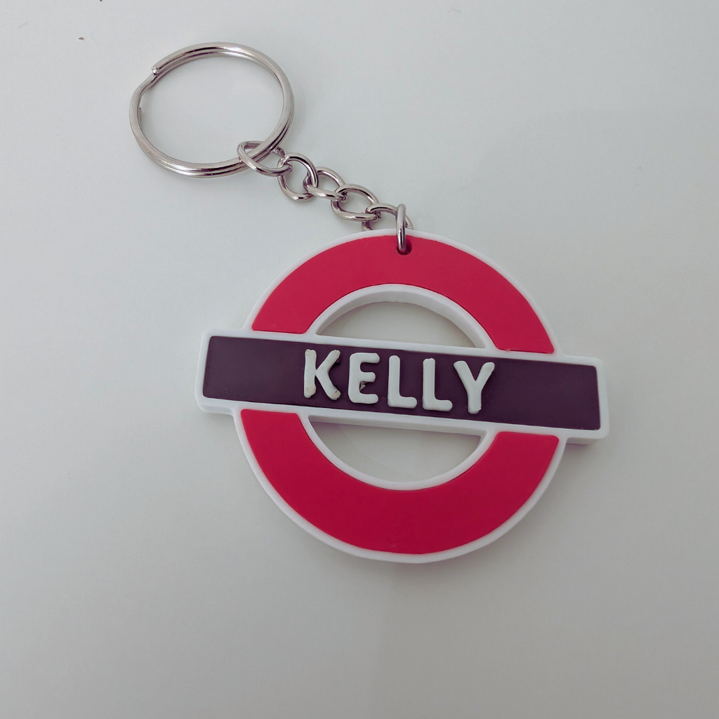 Keychain with a red and white design and 'KELLY' on a white background