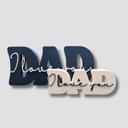 Comparison shot showing the Large Navy DAD plaque next to the Small White DAD plaque, highlighting the two size options available.