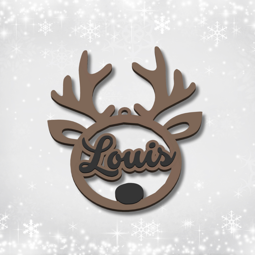 Decorative reindeer ornament with 'Louis' engraved on a light gray background with snowflake patterns.