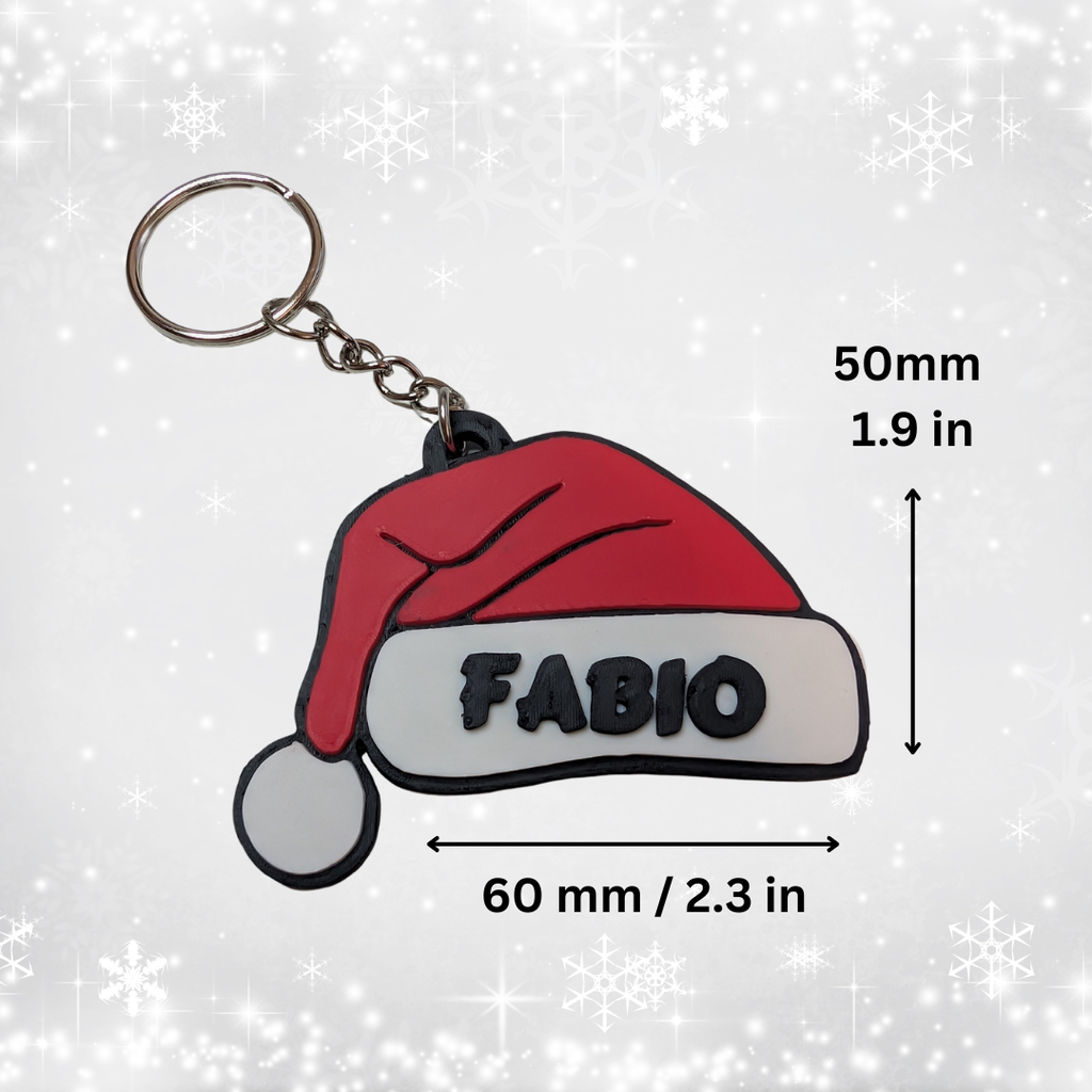 Keychain with red Santa hat and 'FABIO' text, shown with measurements on a light gray background.