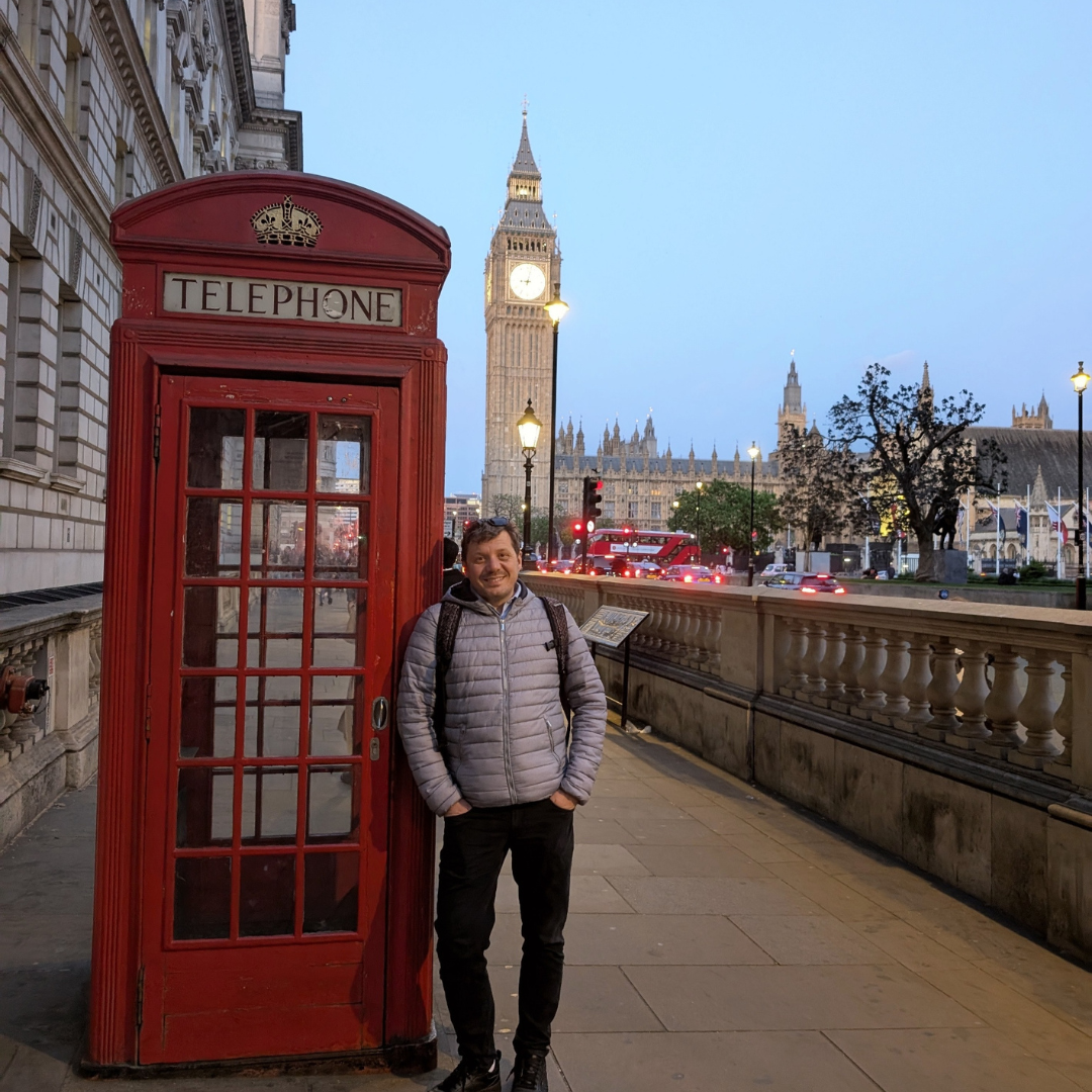 Fabio, founder of Fabiolous Made, in London with Big Ben and a red telephone box.
